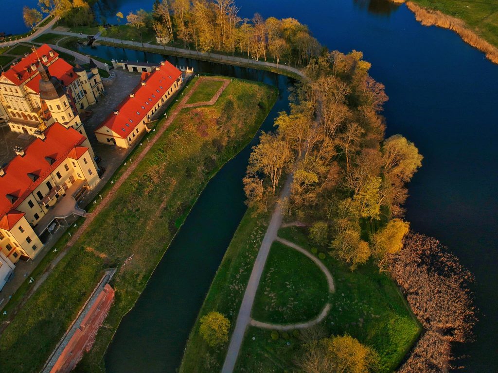 Drone view of medieval castle surrounded by river